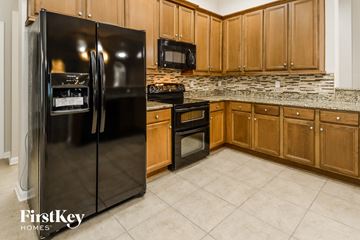 St Augustine house for rent - a kitchen with stainless steel appliances and wooden cabinets