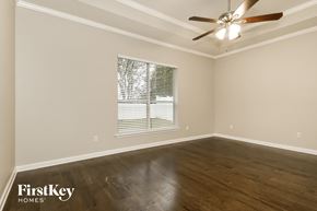 St Augustine house for rent - the living room of a home with wood floors and a ceiling fan