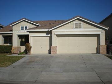 Patterson house for rent - A house with two garages and a driveway.
