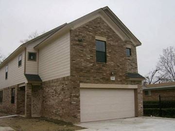 Beaumont apartment for rent - a brick house with a white garage door