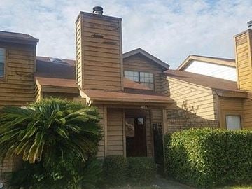 Port Arthur house for rent - a house with a palm tree in front of it