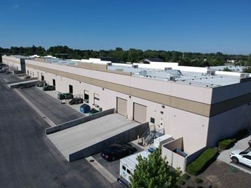 Boise apartment for rent - an aerial view of a white building with a parking lot