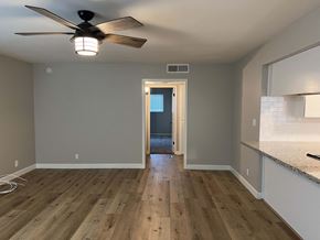 Bakersfield apartment for rent - the view from the kitchen into the living room with a ceiling fan
