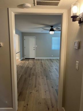 Bakersfield apartment for rent - a living room with wood floors and a ceiling fan