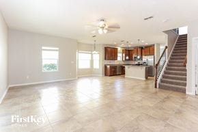 Jacksonville house for rent - A spacious living room with a staircase leading to the upper floor.