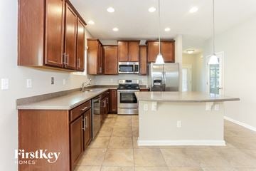 Jacksonville house for rent - A kitchen with brown cabinets and a white island.
