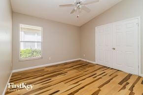 Lake Mary house for rent - the second bedroom with hardwood flooring and a ceiling fan