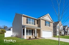 Winston-Salem house for rent - a beige house with a white garage door and a lawn