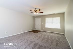Winston-Salem house for rent - the spacious living room with carpet and ceiling fan