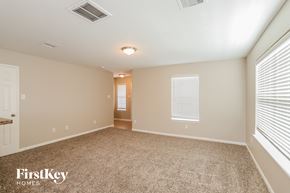 Richmond house for rent - A spacious room with a carpeted floor and a doorway leading to another room.