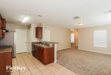 Richmond house for rent - A kitchen with a brown counter top and a white door.