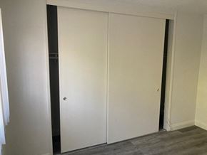 Los Angeles apartment for rent - A white door is closed in a room with grey flooring.