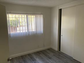 Los Angeles apartment for rent - A room with a sliding door and a window with blinds.