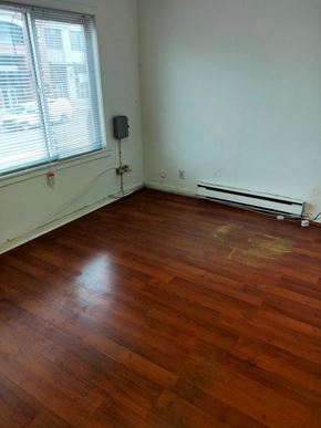 Vancouver apartment for rent - A room with a wooden floor and a window.