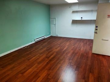 Vancouver apartment for rent - A room with wooden floors and a white door.