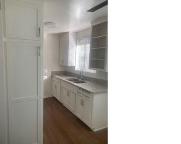 Van Nuys apartment for rent - a kitchen with white cabinets and a sink