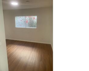 Van Nuys apartment for rent - an empty living room with wood floors and a window