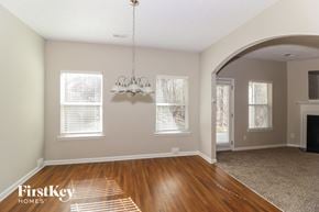 Sugar Hill house for rent - a living room with wood floors and a fireplace and a chandelier