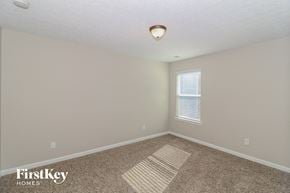 Sugar Hill house for rent - the spacious upstairs bedroom with carpeted flooring and a window