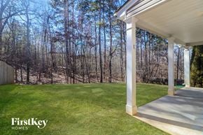 Sugar Hill house for rent - a porch with a lawn and trees in the background