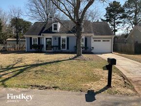 Charlotte house for rent - a small white house with a yard and a tree