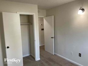 Charlotte house for rent - a bedroom with a closet and a hallway with two doors