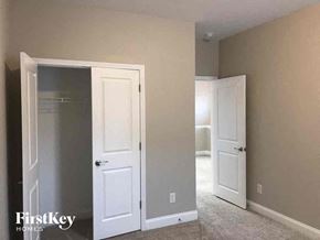 Cramerton house for rent - an empty bedroom with two white doors and a closet