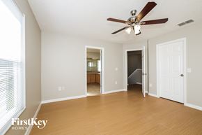 Poinciana house for rent - a living room with wood floors and a ceiling fan