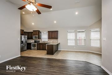 Haslet house for rent - A spacious kitchen and living room with a ceiling fan and recessed lighting.