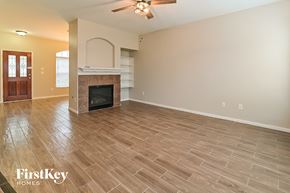 Spring house for rent - A spacious living room with a fireplace and a ceiling fan.
