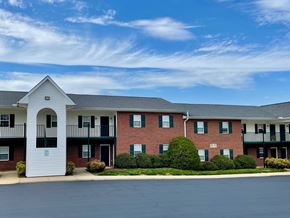Youngsville apartment for rent - A red brick apartment building with a white entrance.