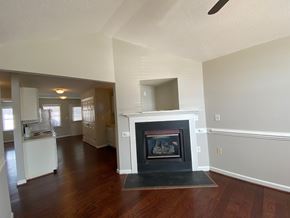 Youngsville apartment for rent - A living room with a fireplace and wood floors.