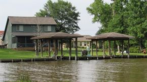 Trinity house for rent - a house on a river with a boat dock