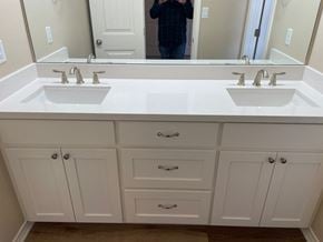 Trinity house for rent - A bathroom with two sinks and white cabinets.