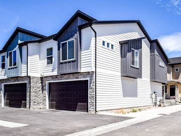 North Logan apartment for rent - a white house with a garage and a blue sky