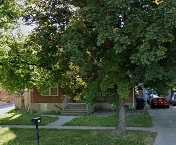 Logan apartment for rent - a tree in front of a brick house