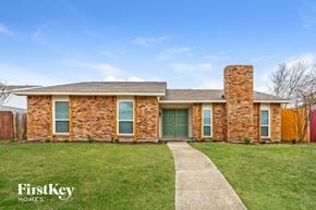 Carrollton house for rent - a brick house with a green front door and a lawn