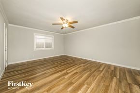 Carrollton house for rent - the living room of a home with wood floors and a ceiling fan
