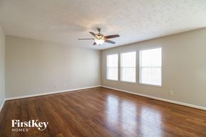 Amelia house for rent - a living room with wood floors and a ceiling fan