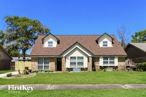 Houston house for rent - front view of a home with green grass and a blue sky