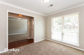 Houston house for rent - a living room with a large window and a door to a hallway