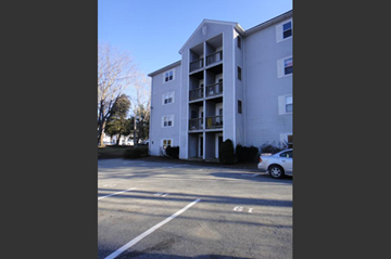 Millbury apartment for rent - an empty parking lot in front of an apartment building