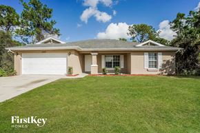 Lehigh Acres house for rent - A house with a garage door numbered 1022 is for sale.