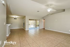 Lehigh Acres house for rent - A spacious room with tiled flooring and a ceiling fan.