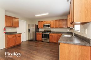 Charlotte house for rent - a kitchen with wooden cabinets and stainless steel appliances