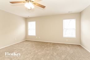 Charlotte house for rent - a bedroom with carpet and a ceiling fan