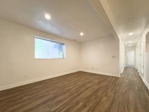 Provo apartment for rent - a living room with white walls and wooden floors and a window