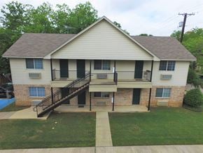 Denton apartment for rent - a large white house with a balcony and a yard