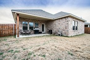 Aubrey house for rent - A house with a brown fence and a brown roof.