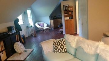 Denton house for rent - A living room with a white couch and a white chair.